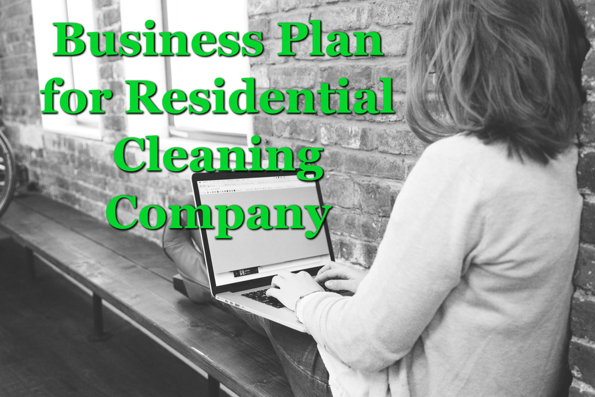 A woman at a laptop working on a business plan for a residential cleaning company
